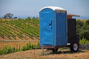 deluxe porta potty near a wine vineyard