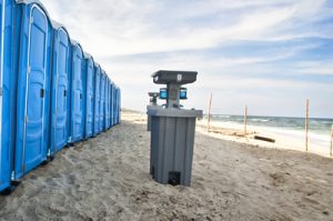 Line of porta potties and a hand washing station at the beach in arlington, tx